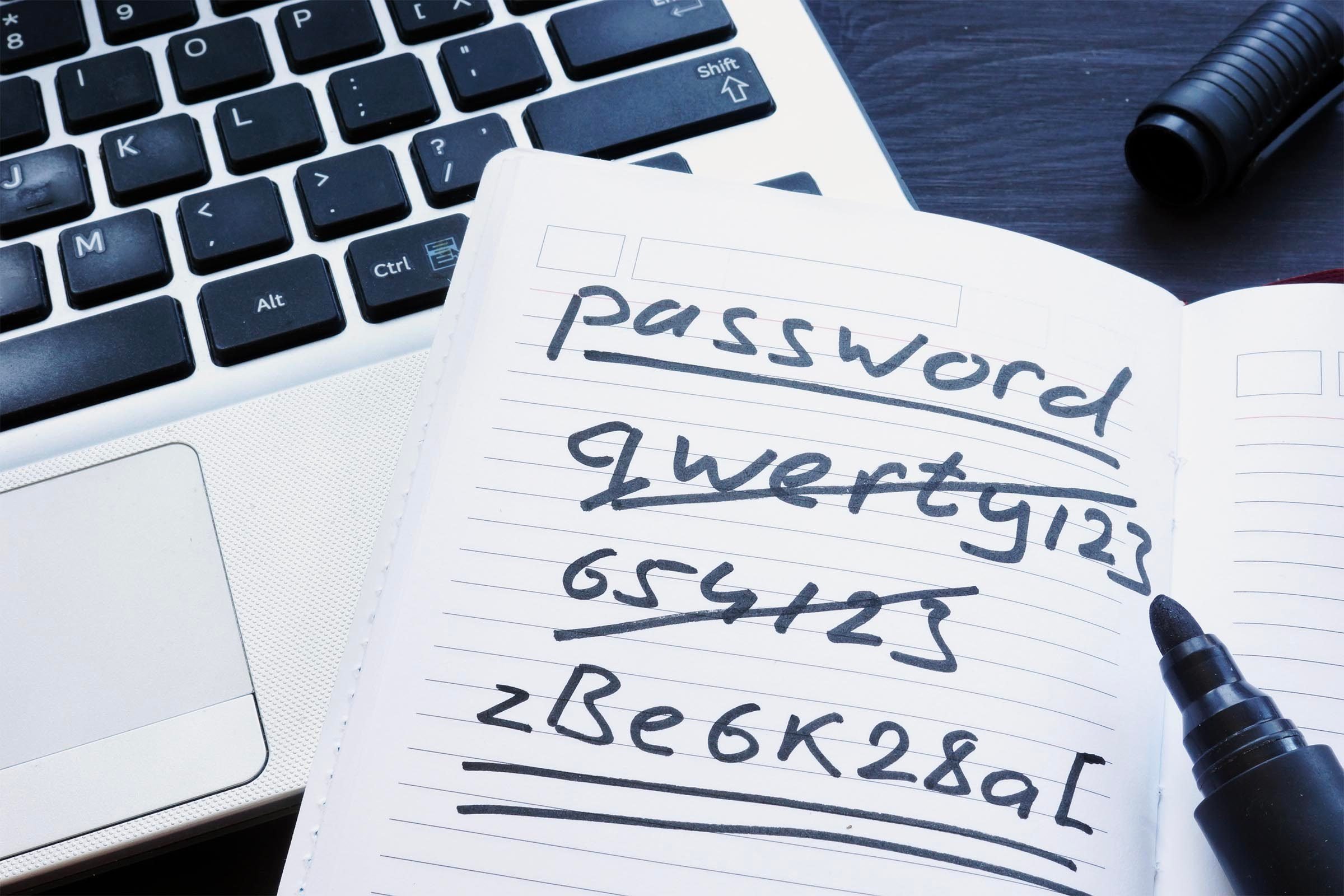 Most Common Passwords list placed on open laptop keyboard