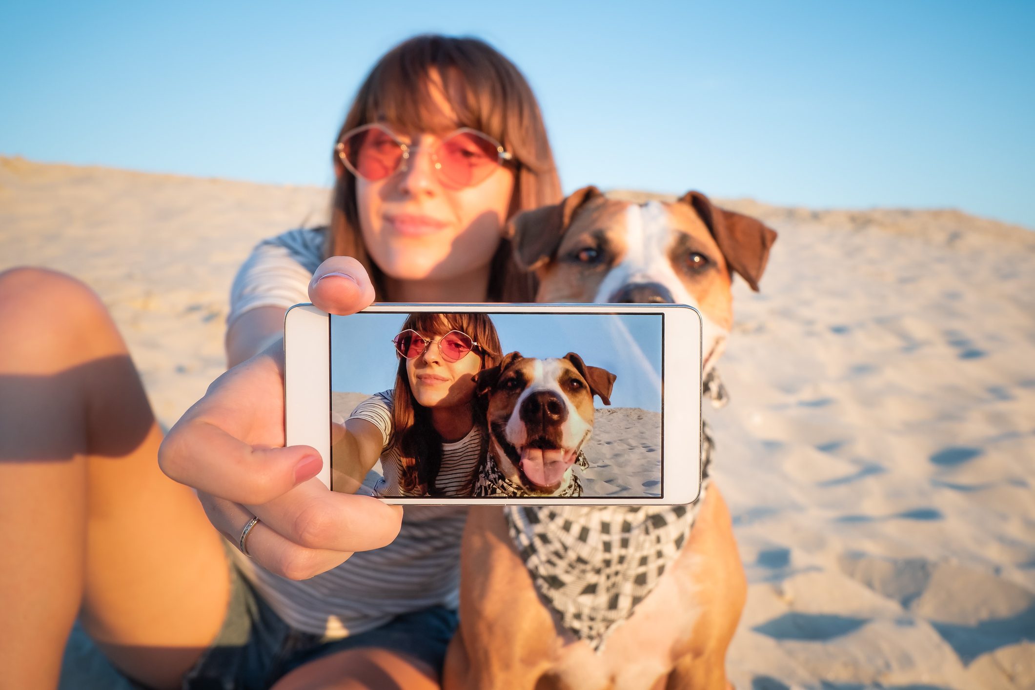 Human taking a selfie with dog.