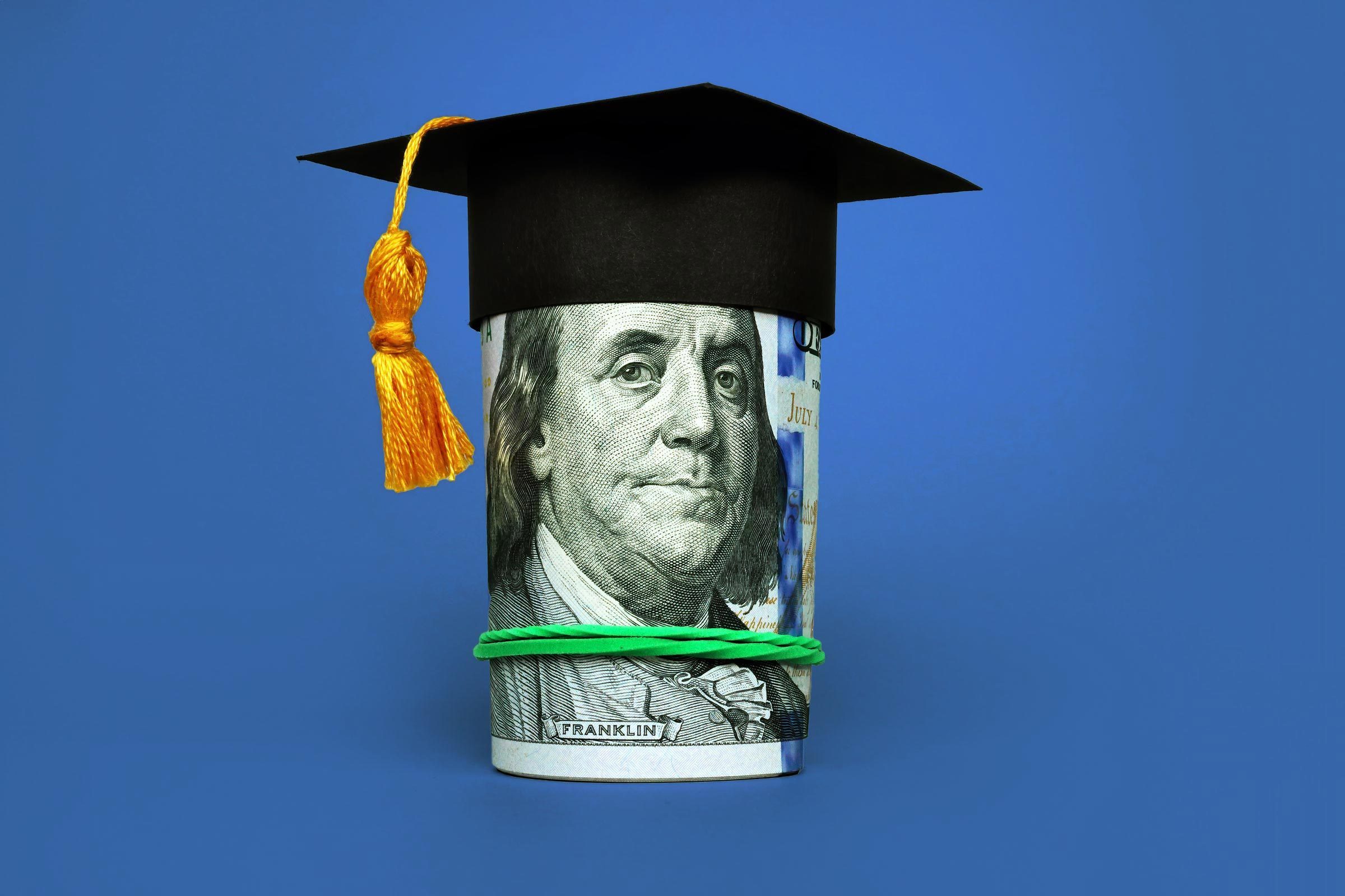 roll of money with graduation cap