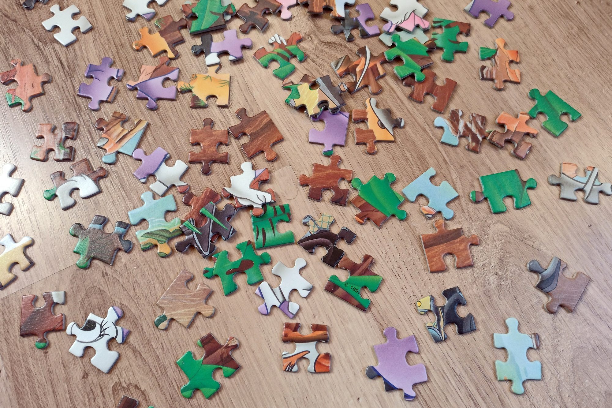 colorful puzzle pieces on a wooden background