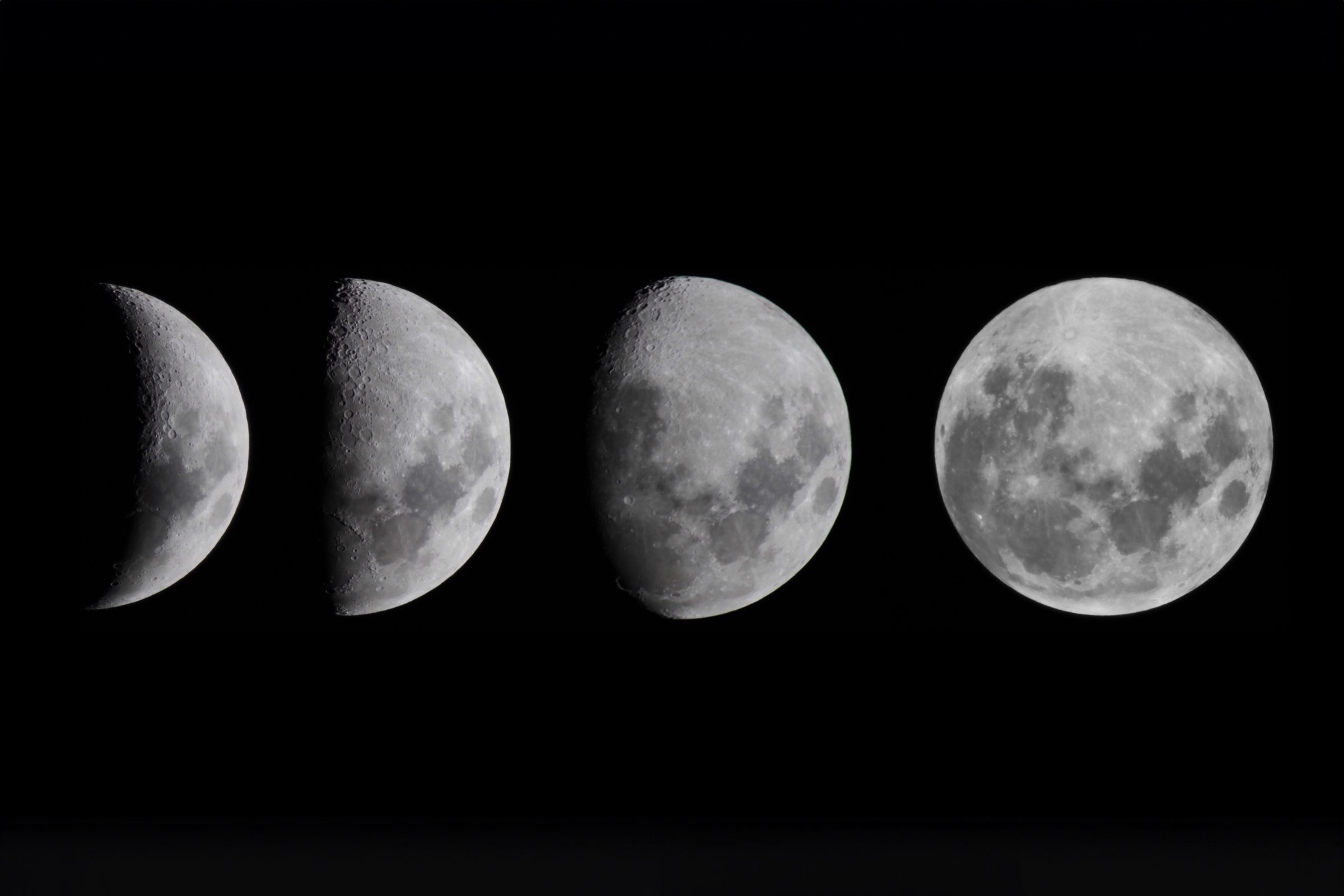 4 moon phases on black
