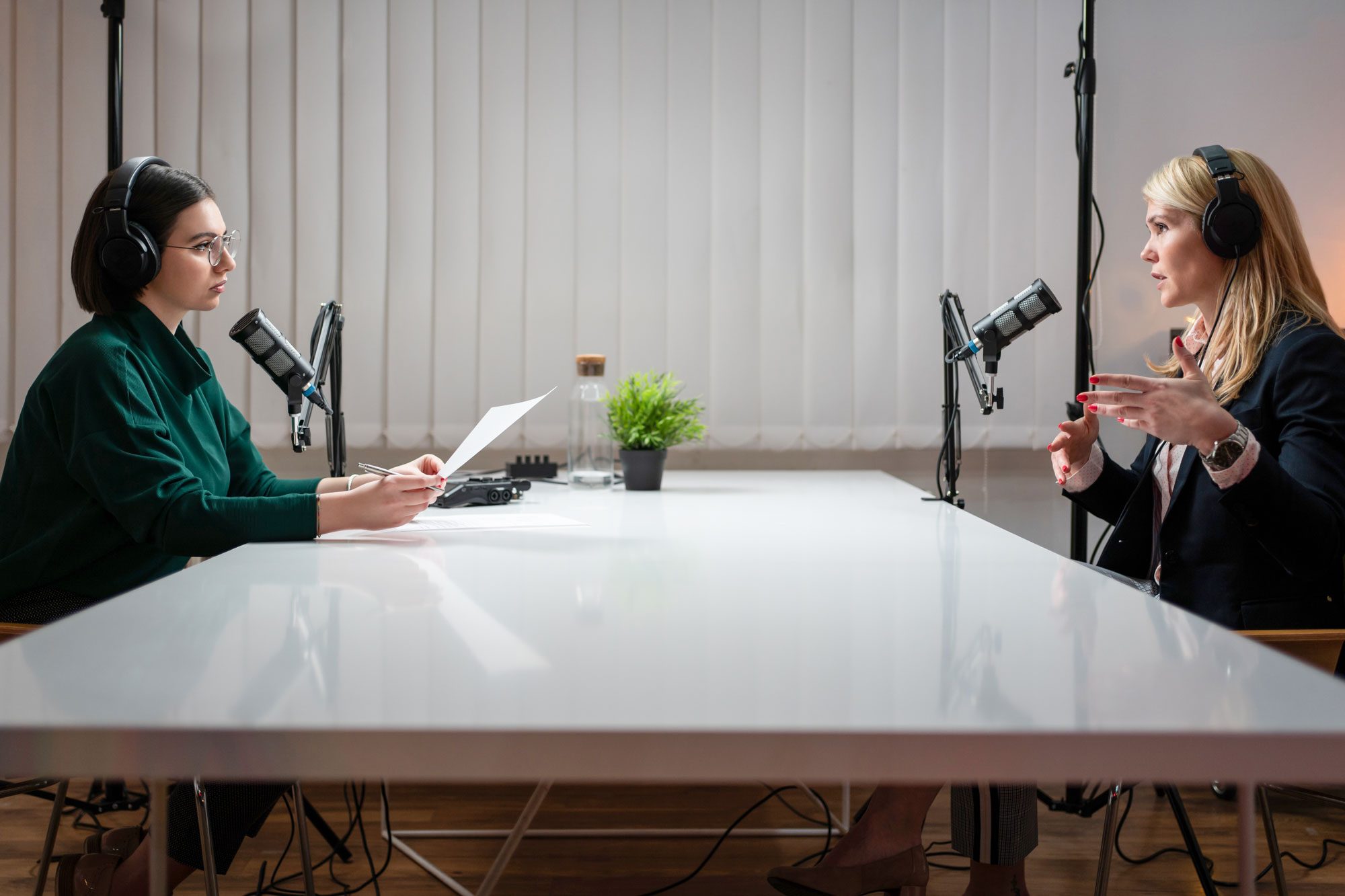 Side View Of Two Women Talking On A Podcast