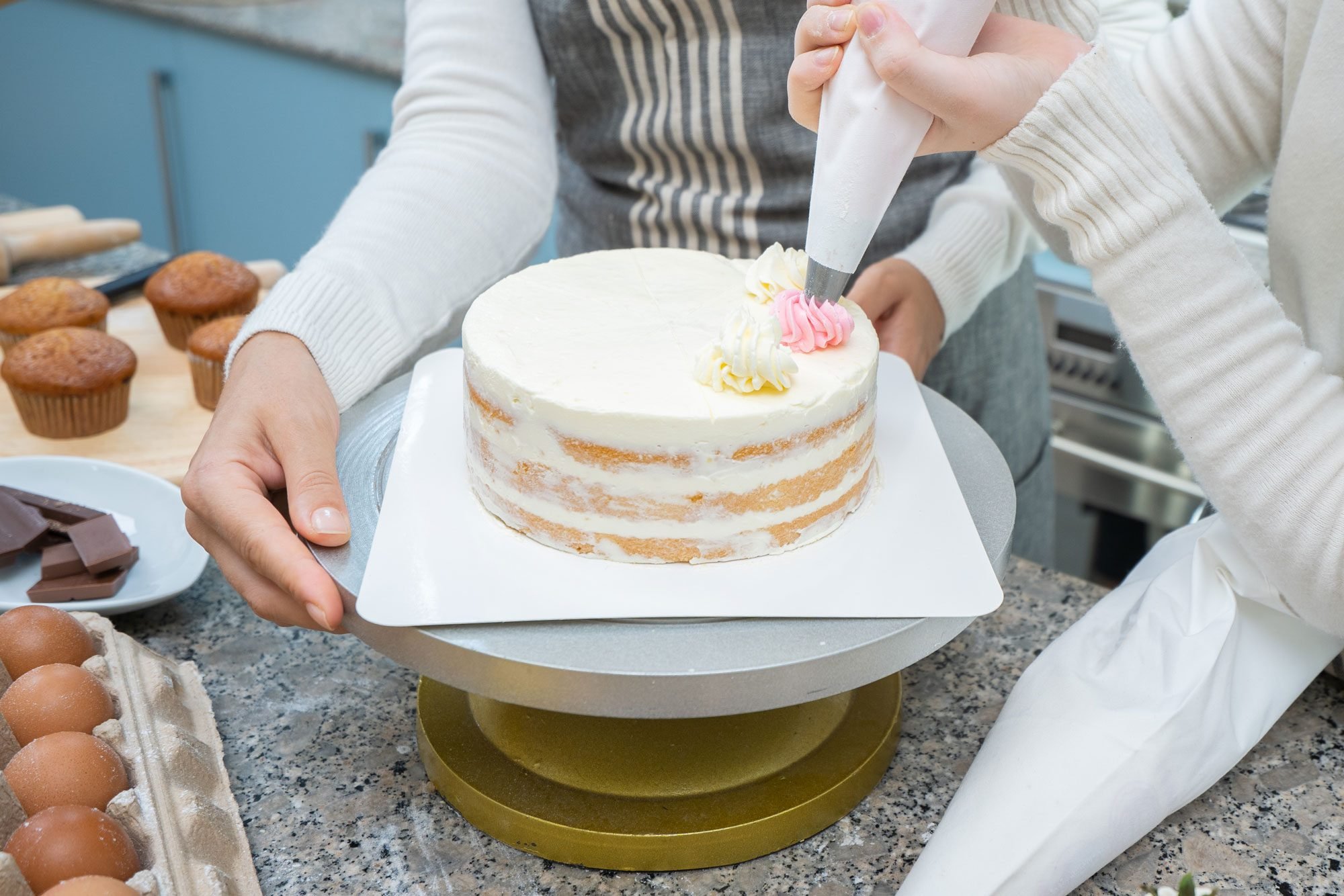 Young Caucasian Kid Decorating Whipped Cream On The Cake