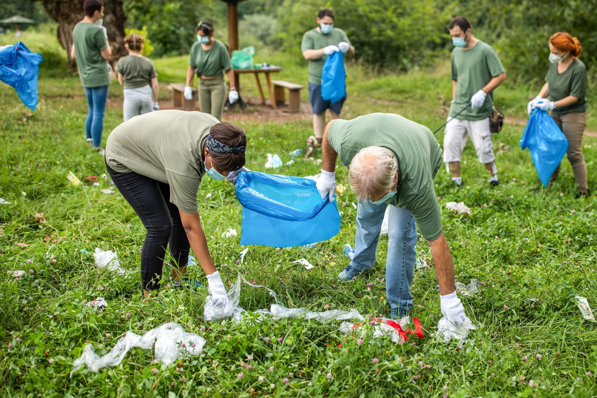 Multi Ethnic Group Of Volunteers Cleaning Public Park Wearing Protective Face Masks