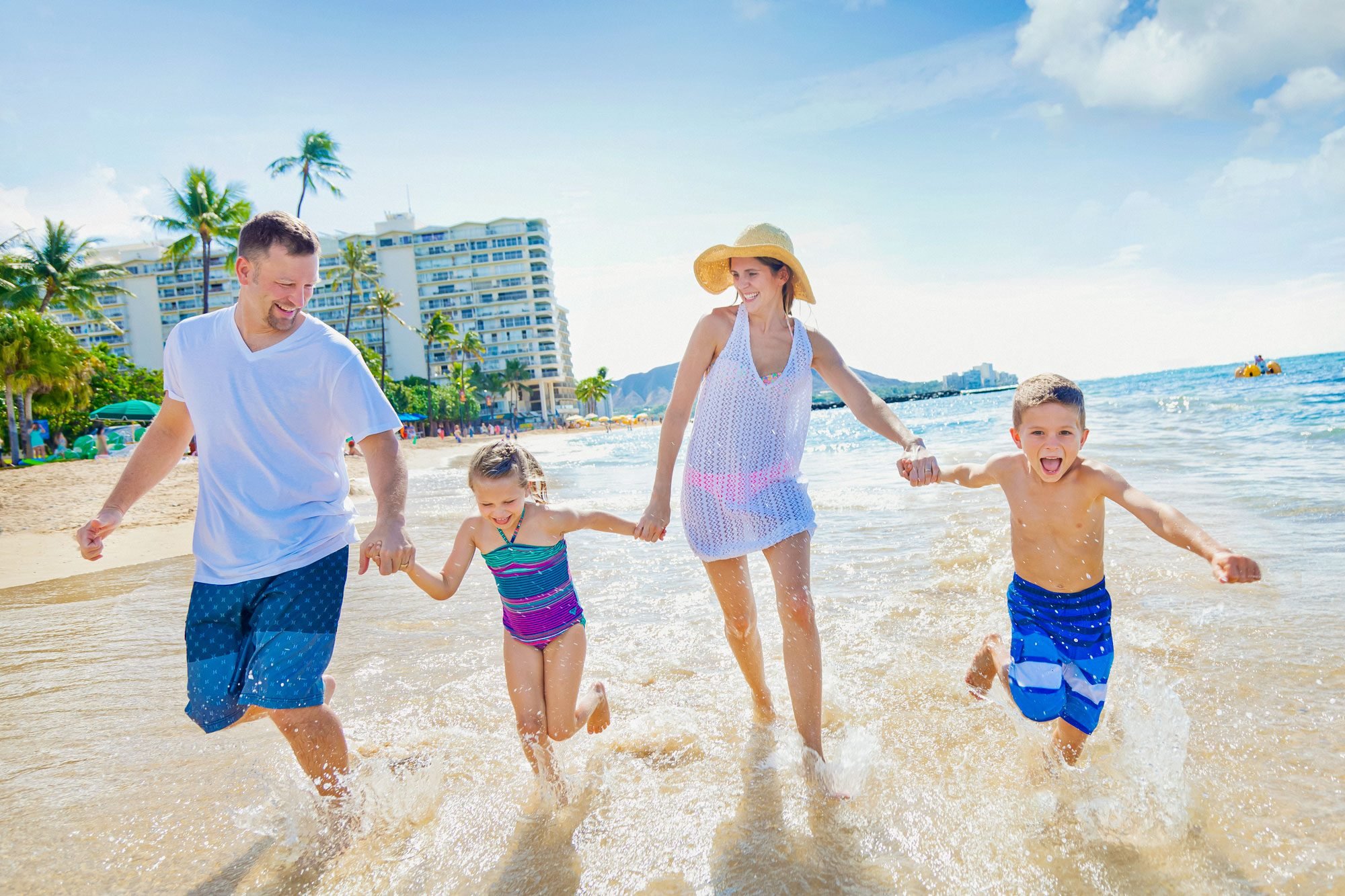 A Family Of Four Enjoying A Summer Vacation In Waikiki Beach Hawaii