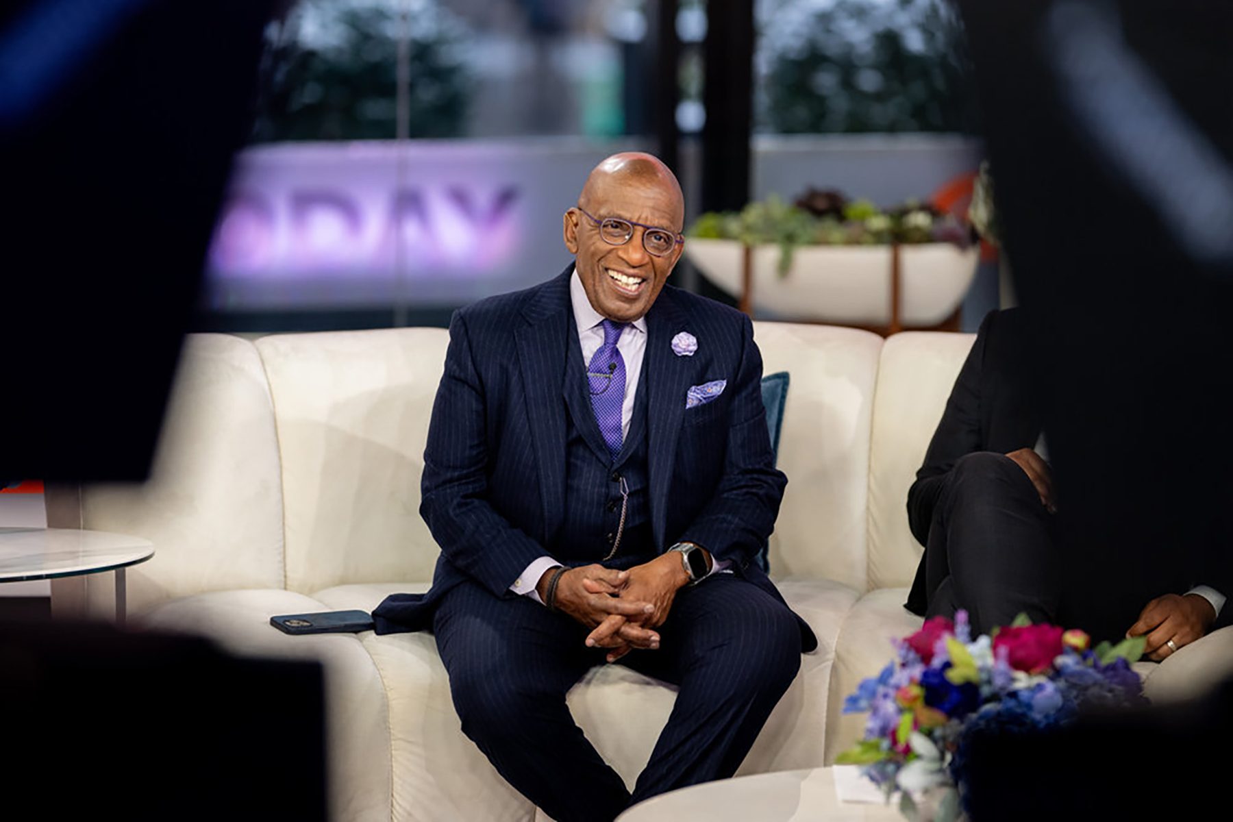 Al Roker sitting on a white couch