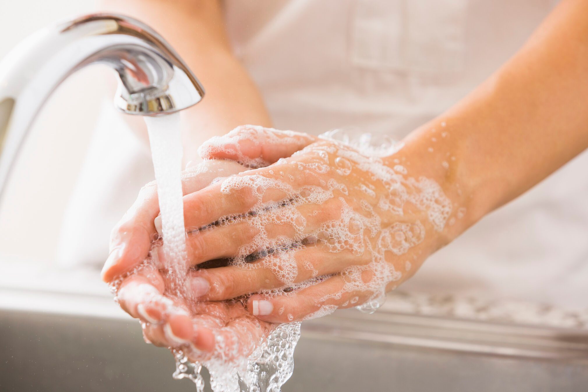 Caucasian woman washing her hands